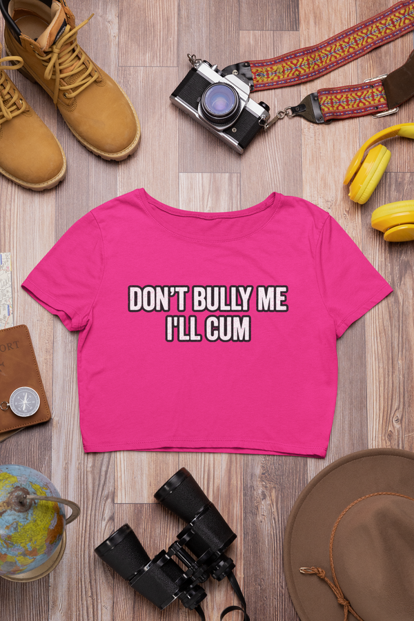 Vibrant pink crop top displaying bold text: "DONT BULLY ME IL'L CUM"